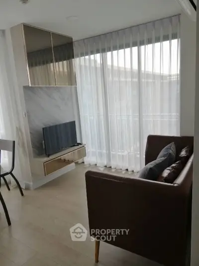 Modern living room with sleek furniture and large windows