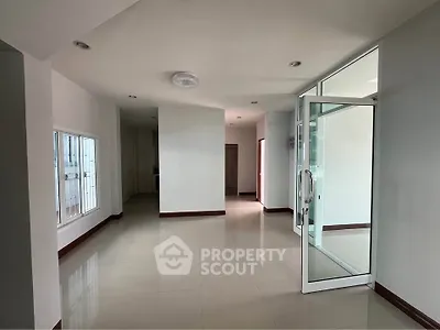 Spacious modern interior with large windows and glass door, perfect for natural light.