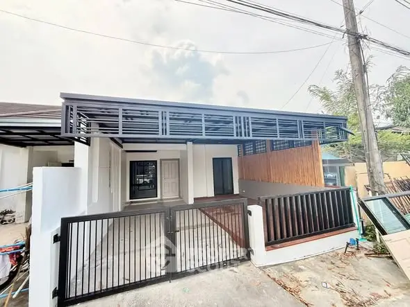Modern single-story house with sleek gate and covered carport
