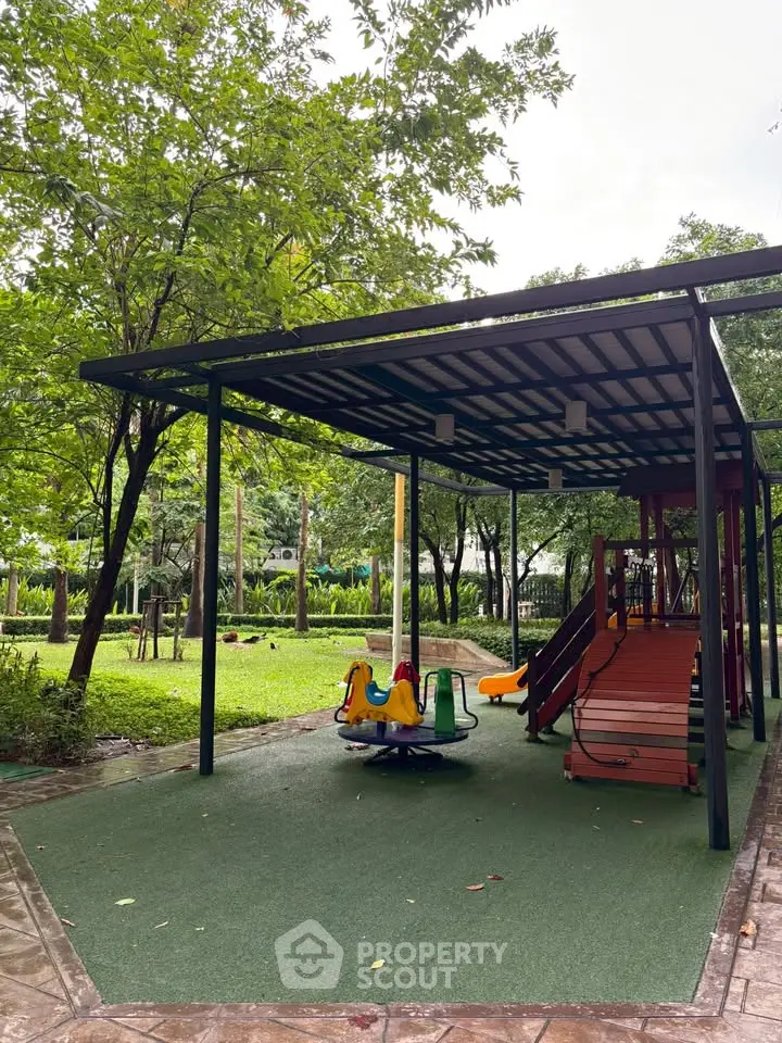 Charming outdoor playground area in a lush green garden setting, perfect for family-friendly living environments.