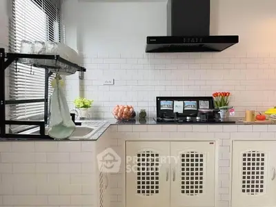 Charming kitchen with modern appliances and stylish white tile backsplash