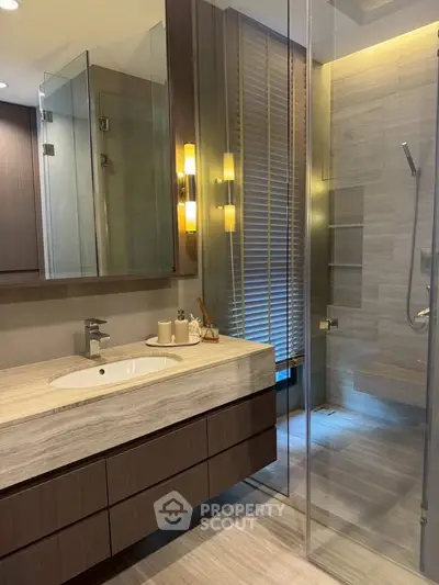 Luxurious modern bathroom with glass shower and elegant lighting