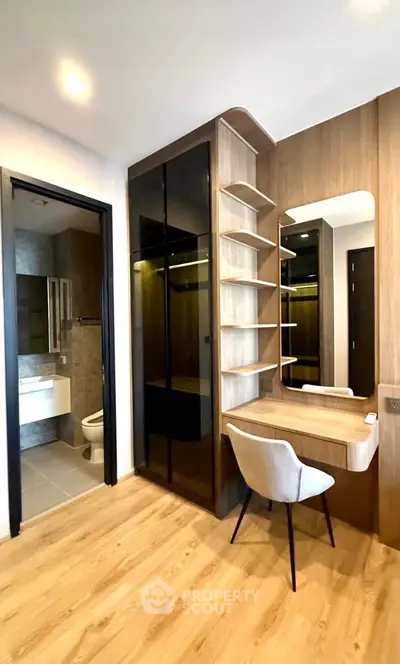 Modern bedroom with sleek wooden flooring and stylish vanity area