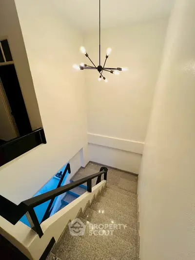 Elegant staircase with modern chandelier in a stylish home interior