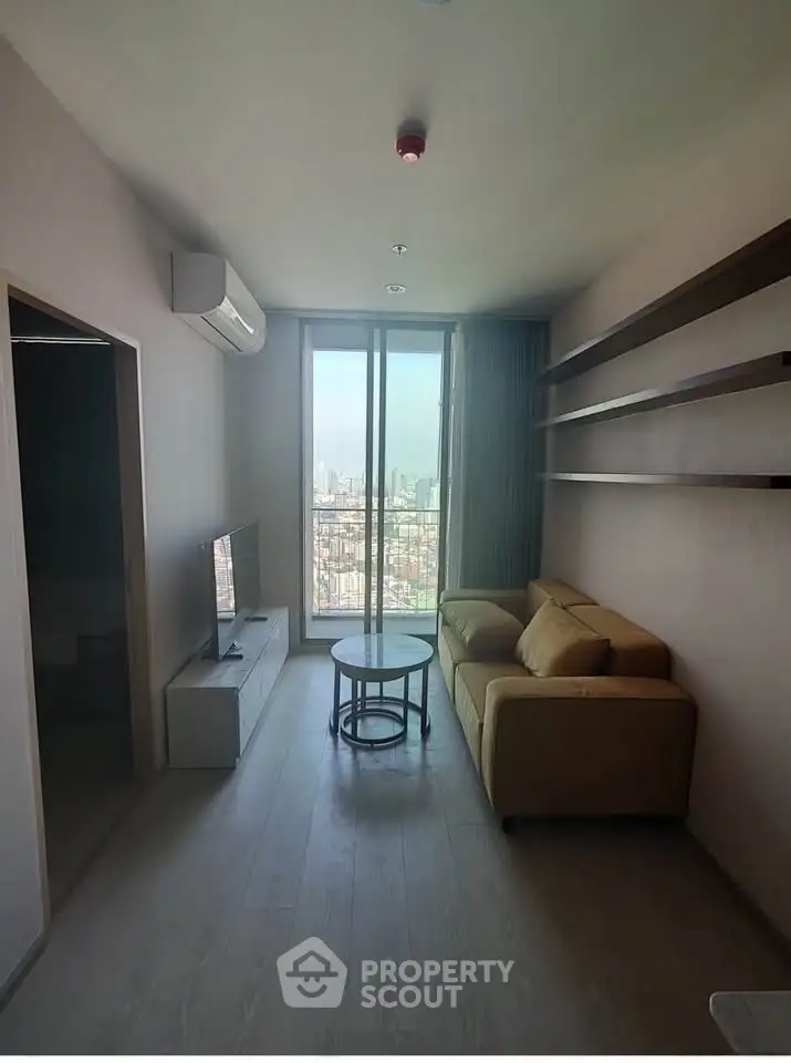 Modern living room with city view, cozy sofa, and sleek TV setup