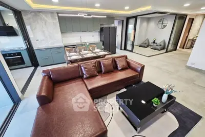 Luxurious open-plan living room with modern kitchen and stylish decor