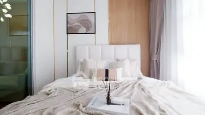Luxurious bedroom with elegant decor and soft lighting, perfect for relaxation and comfort.