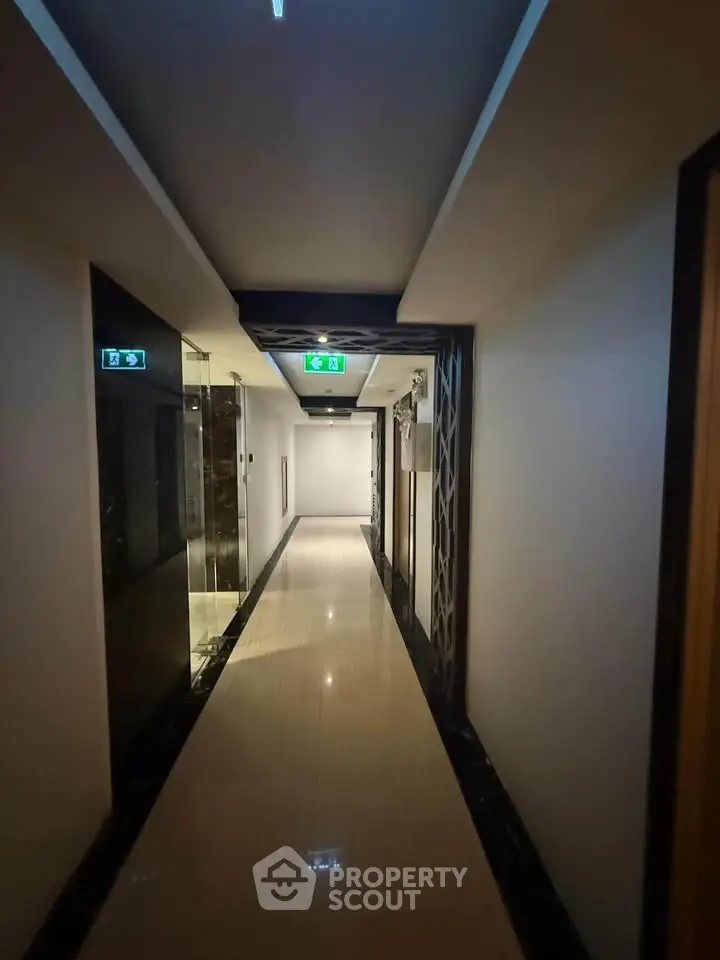 Modern hallway with sleek design and polished floors in upscale building.