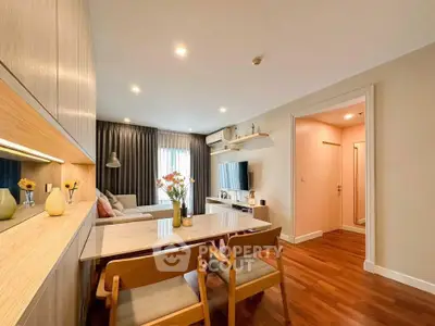 Modern living room with stylish decor and wooden flooring in a cozy apartment.