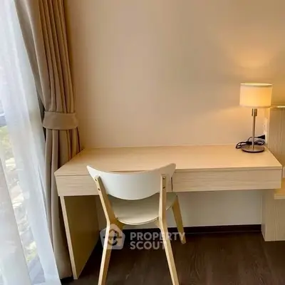 Cozy study area with elegant desk and chair by window, perfect for productivity.