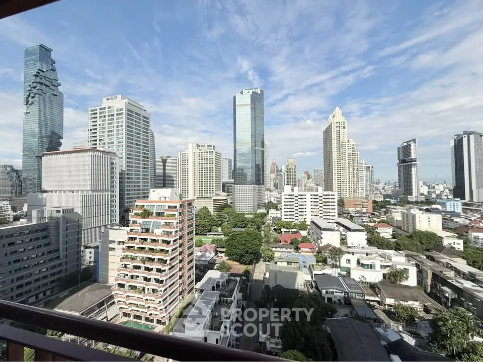 Stunning city skyline view from a high-rise balcony, showcasing modern skyscrapers and lush greenery.