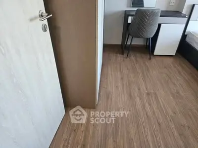 Modern bedroom with wooden flooring and stylish furniture