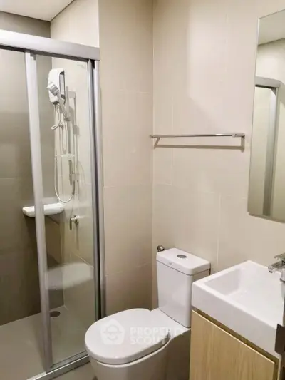 Modern bathroom with sleek shower and compact design in a contemporary apartment.