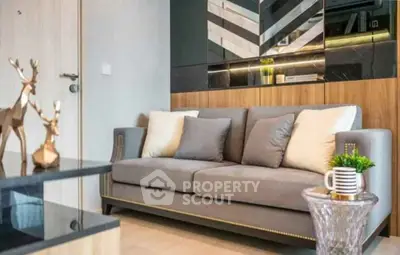 Modern living room with stylish sofa and decorative accents in a contemporary apartment.