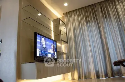 Modern living room with sleek TV unit and elegant curtains