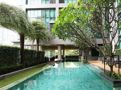Luxurious condominium with stunning poolside view and lush greenery