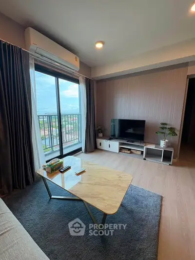 Modern living room with large window and stylish decor, offering a cozy and inviting atmosphere.