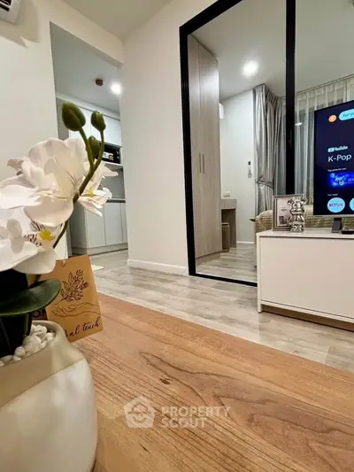 Modern living room with stylish decor and open view to bedroom