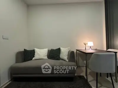 Cozy living room with modern sofa and stylish dining area, perfect for relaxation and entertaining.