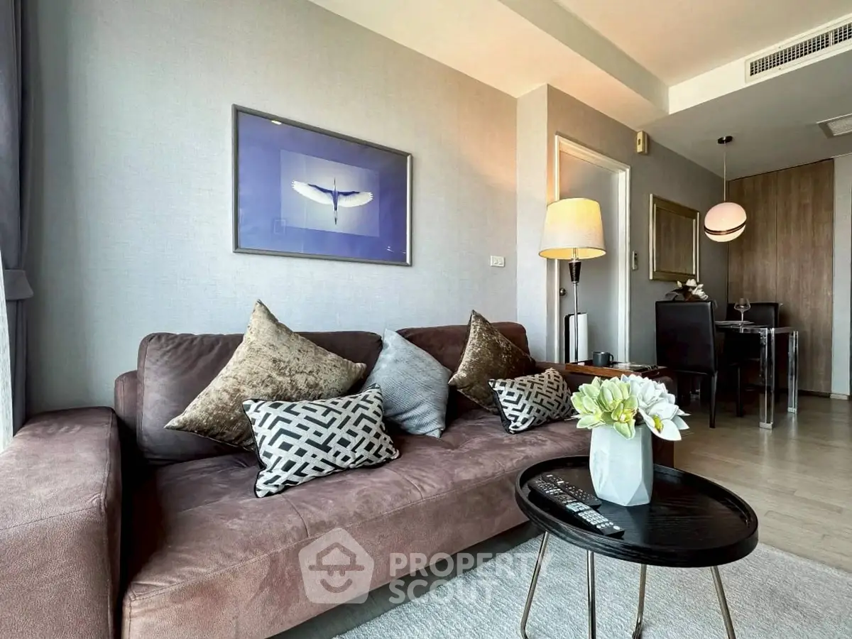 Modern living room with stylish decor, cozy sofa, and elegant dining area in a contemporary apartment.