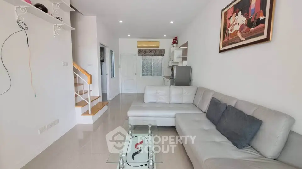 Modern living room with sleek white sectional sofa and glass coffee table