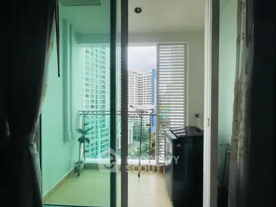 Modern apartment balcony with city view and laundry area