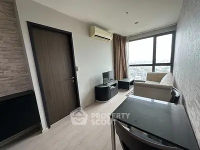 Modern living room with city view, featuring sleek furniture and air conditioning.