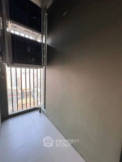 Compact balcony with city view and air conditioning units, ideal for urban living.