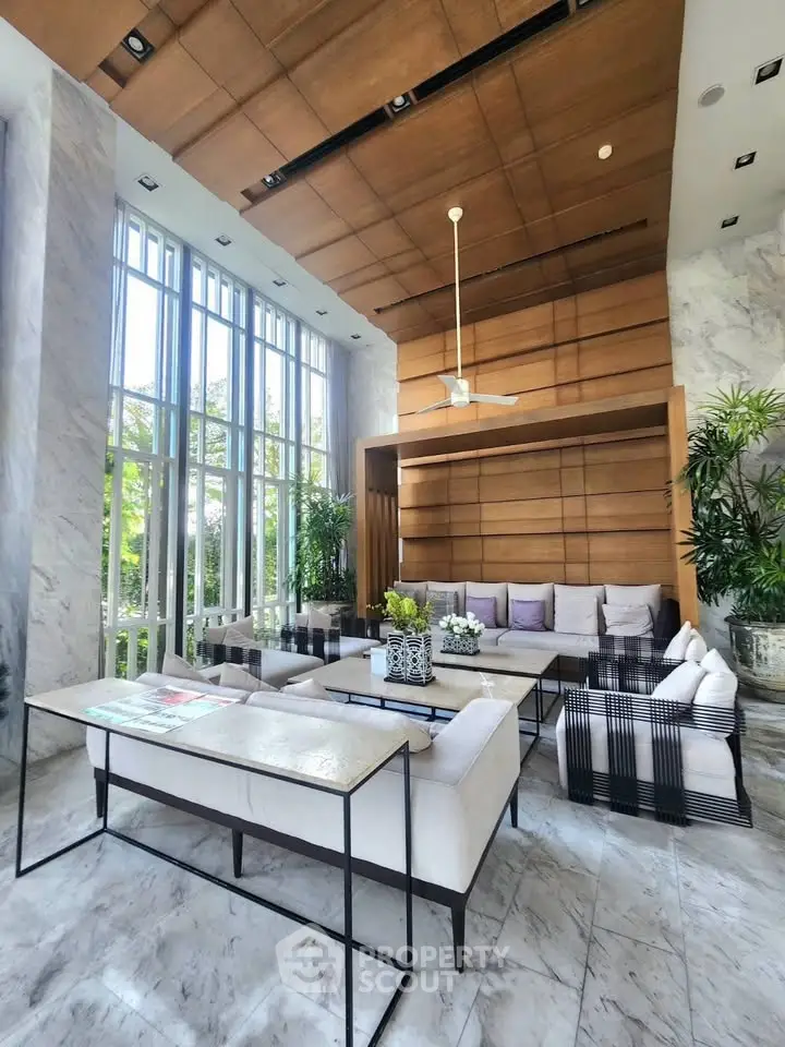Luxurious modern living room with high ceilings, large windows, and elegant marble flooring.