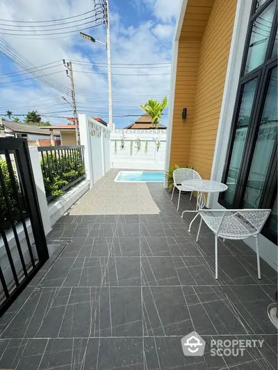 Charming patio with pool and seating area in modern home exterior