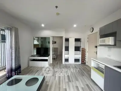 Modern living room with sleek furniture and open kitchen layout