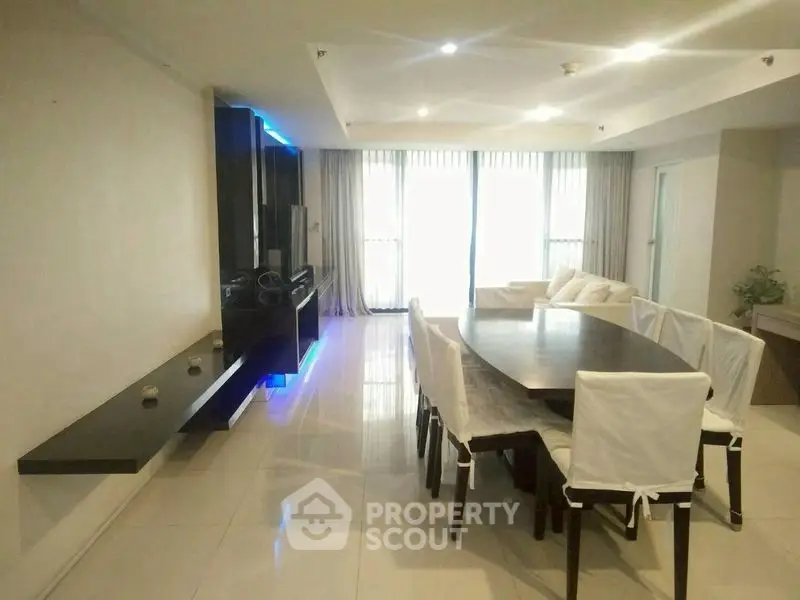 Spacious modern dining area with sleek table and ambient lighting