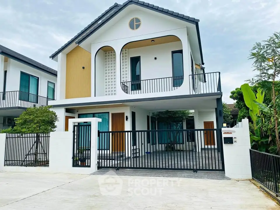 Modern two-story house with stylish facade and spacious balcony in a serene neighborhood.