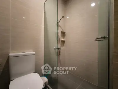 Modern bathroom with glass shower and sleek tile design