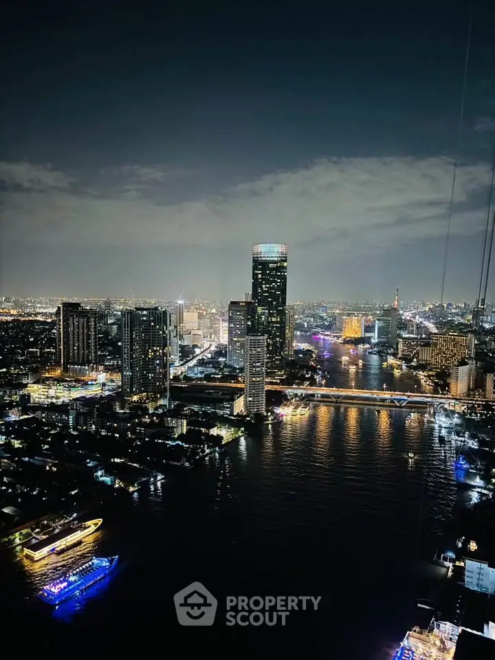 Stunning nighttime cityscape view with illuminated skyscrapers and river, perfect for urban living enthusiasts.