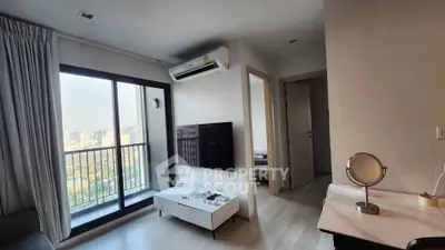 Modern living room with city view, featuring sleek furniture and air conditioning, perfect for urban living.