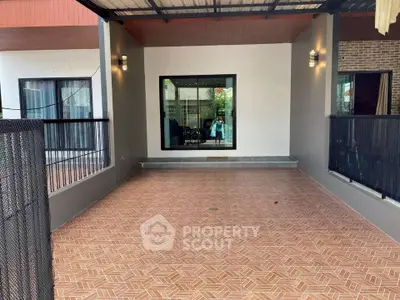 Spacious covered patio with tiled flooring and modern lighting, perfect for outdoor relaxation.