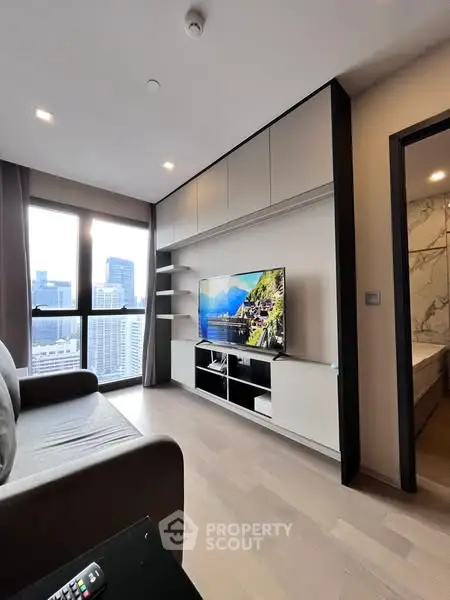 Modern living room with city view and sleek entertainment center