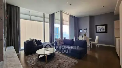 Spacious modern living room with elegant decor and large windows offering natural light.