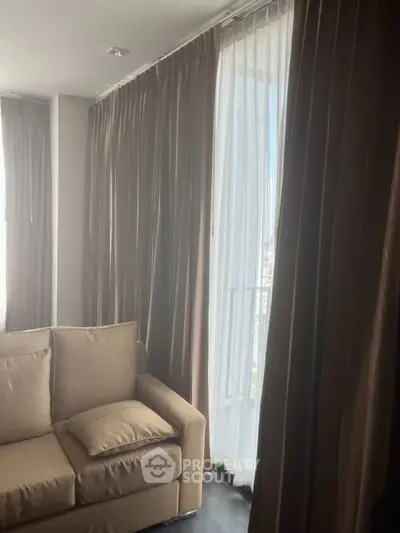 Cozy living room with elegant curtains and plush sofa, perfect for relaxation.