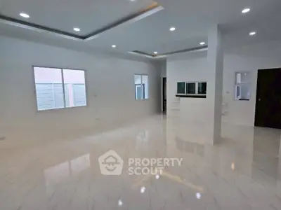 Spacious modern living room with sleek marble flooring and recessed lighting