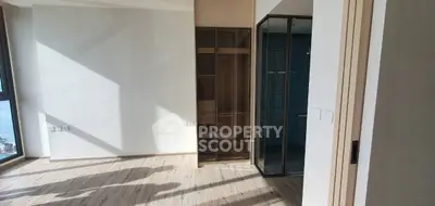 Bright modern apartment interior with large windows and wooden flooring