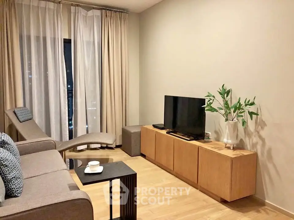 Modern living room with sleek furniture and natural light, perfect for relaxation and entertainment.