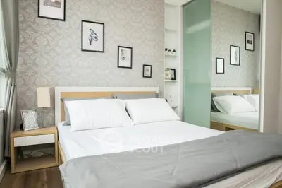 Modern bedroom with stylish decor, featuring a comfortable bed and elegant wall art.