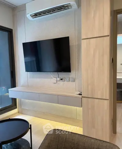 Modern living room with wall-mounted TV and sleek air conditioning unit.