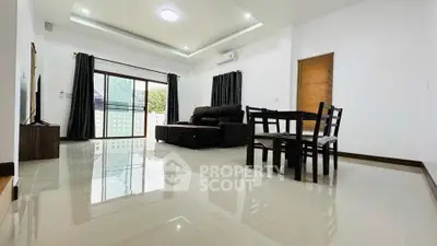 Spacious modern living room with sleek furniture and large windows for natural light.