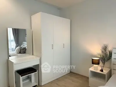 Modern bedroom with sleek white furniture and cozy lighting