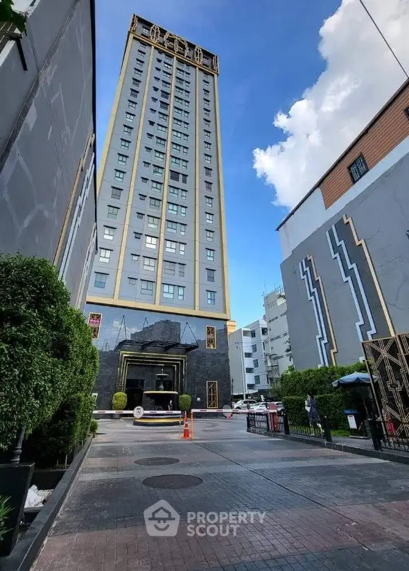 Stunning high-rise building with modern architecture and lush greenery in urban setting.