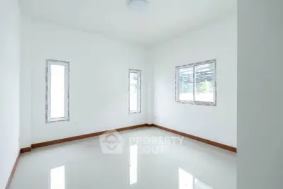 Bright empty room with glossy white tiles and large windows