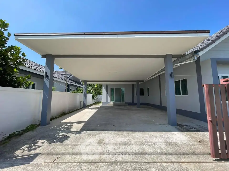 Spacious covered parking area in modern residential property with sleek design and ample space.